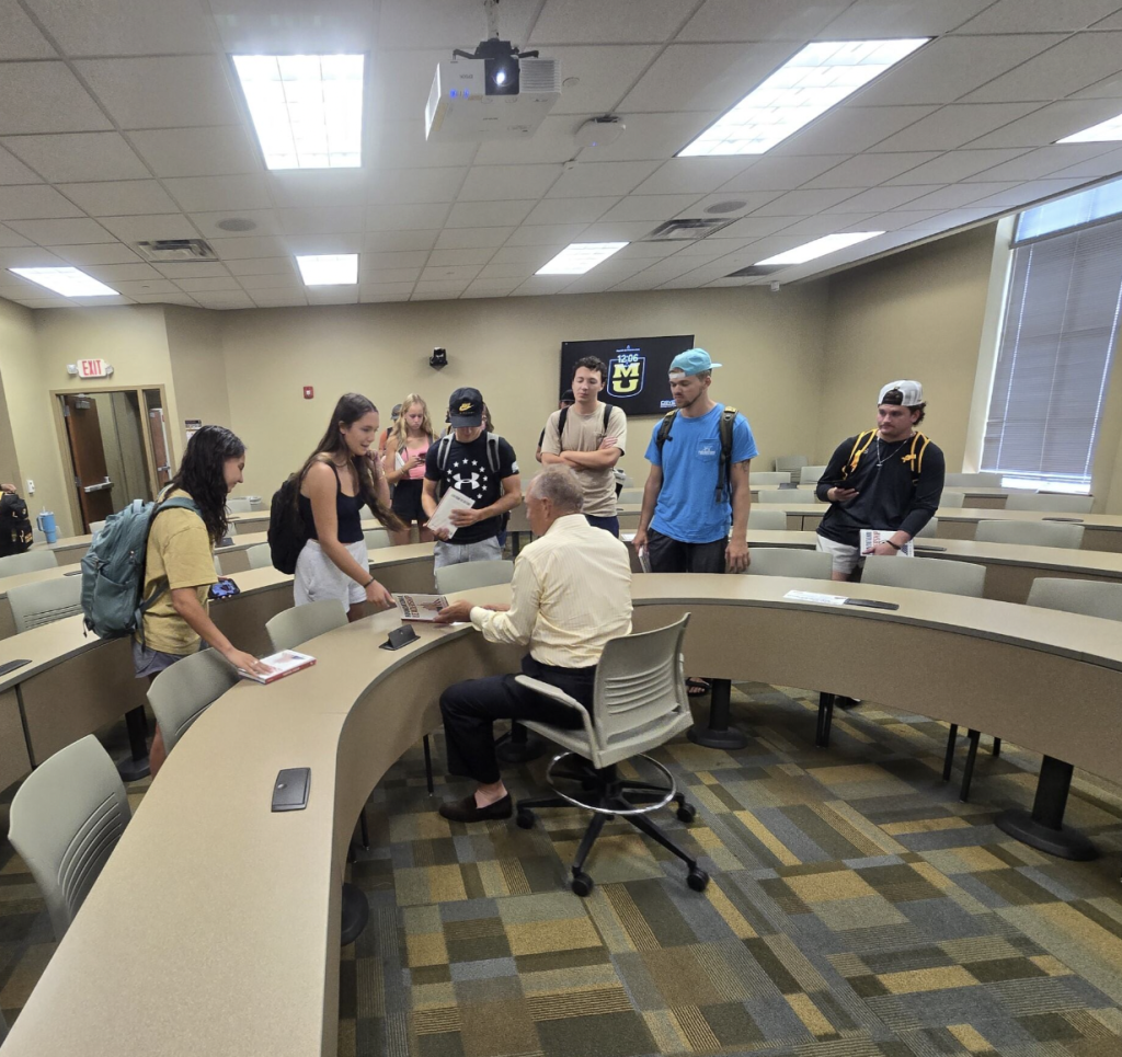 Robert Griggs, CEO of Trinity Products, signing copies of his book Foundational Leadership for students, inspiring the next generation of leaders.